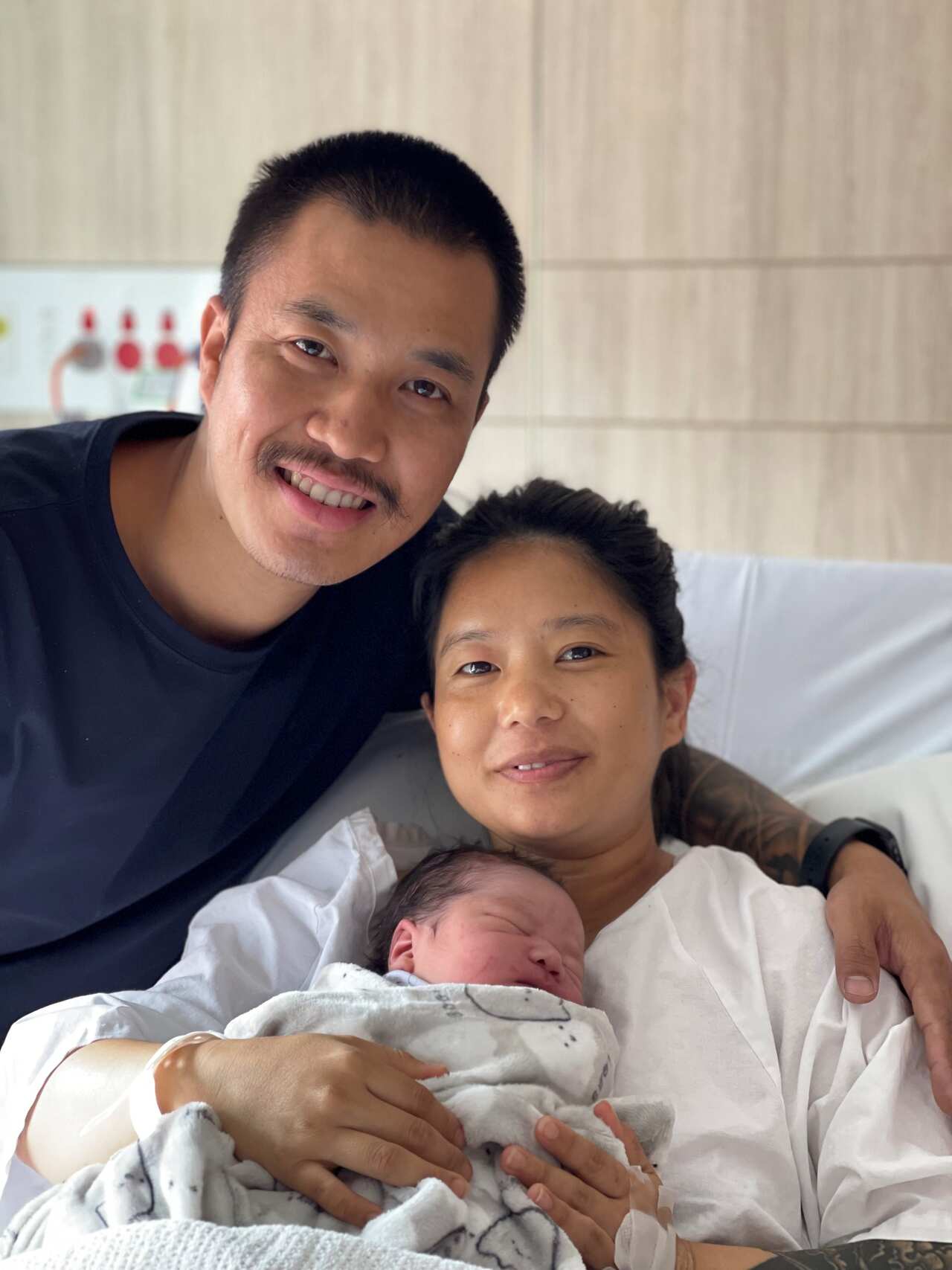 Chitra and Mamata hold their newborn in their arms. 