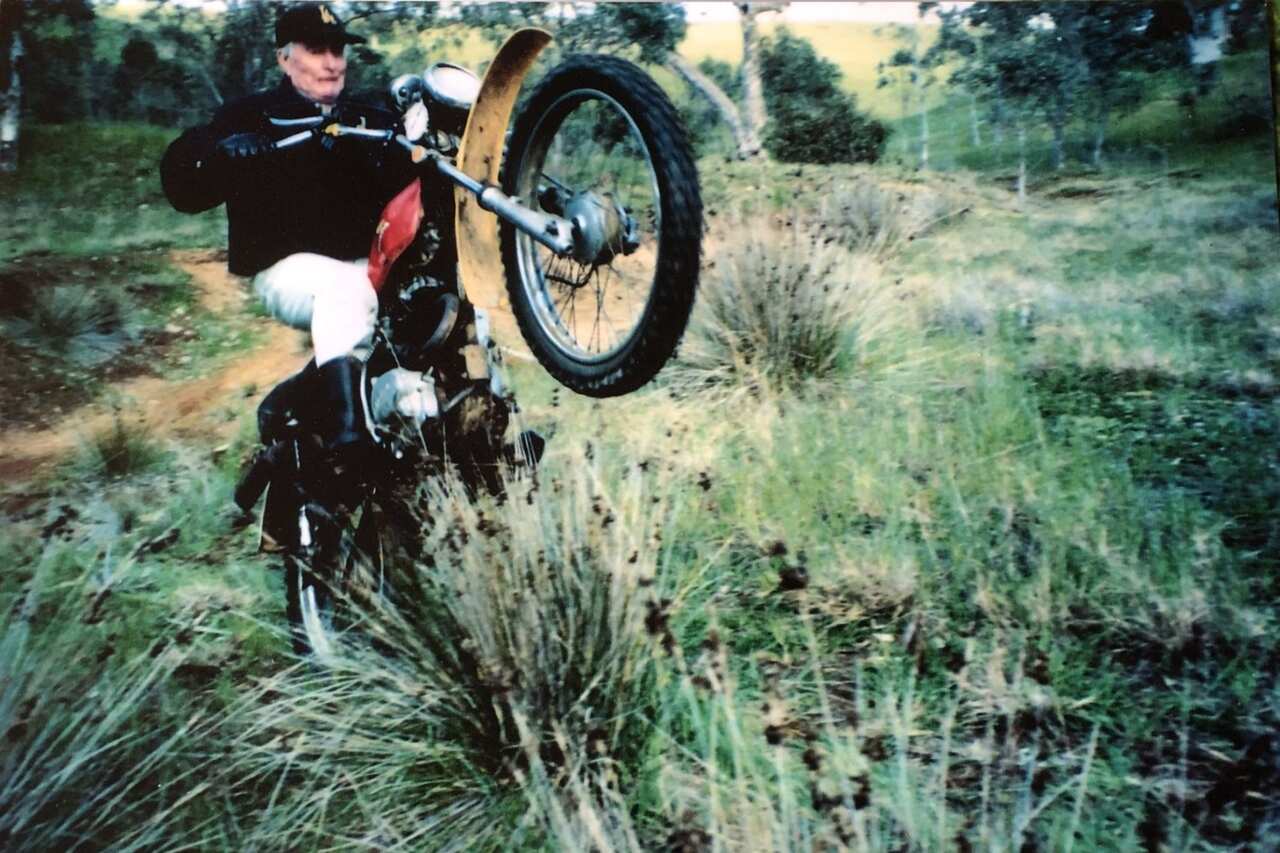 Colin Wagener manoeuvres his bike so it is balanced on the back wheel, while he is still on the bike. 