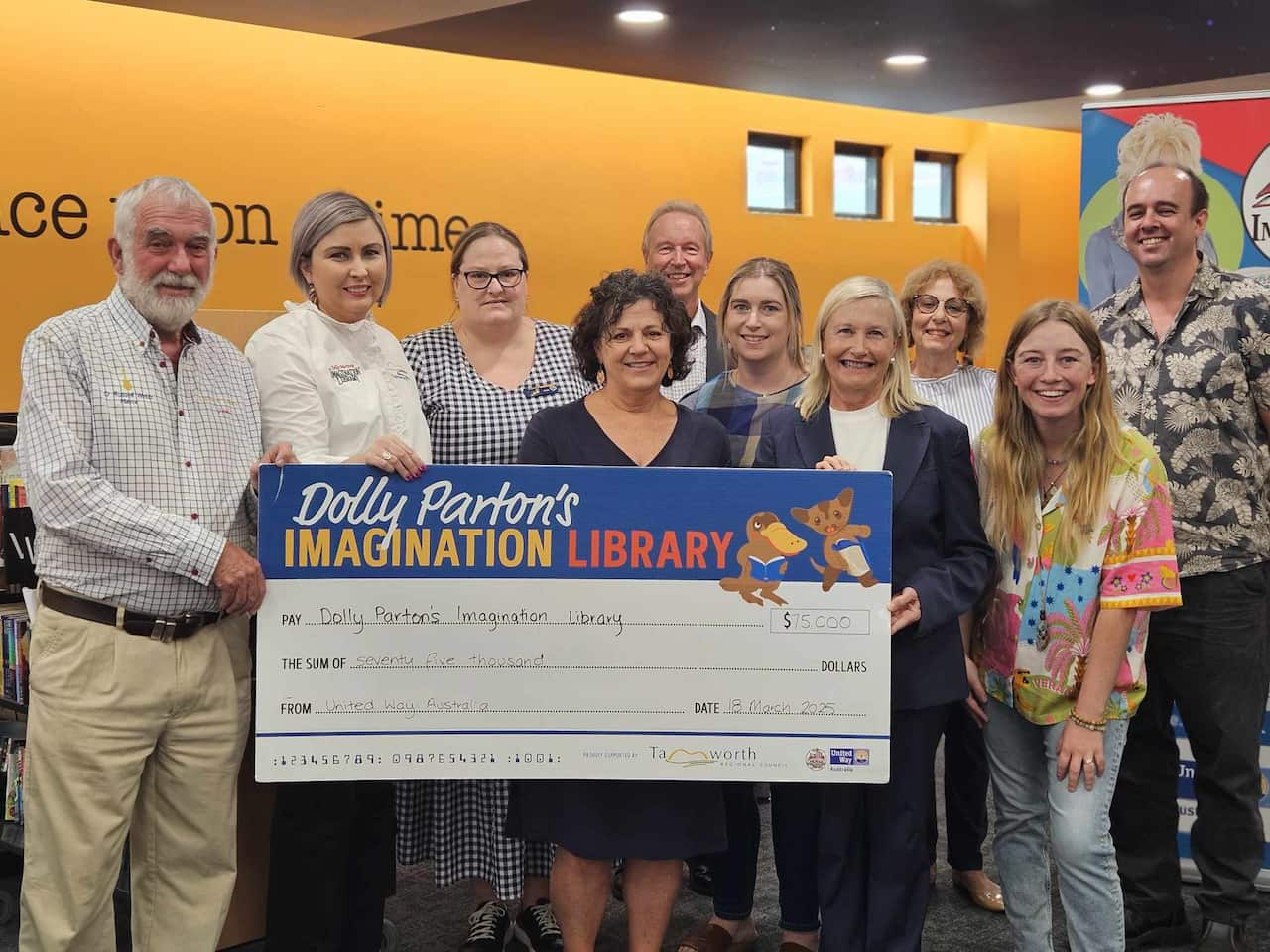 Staff of the Imagination Library with an oversized cheque.