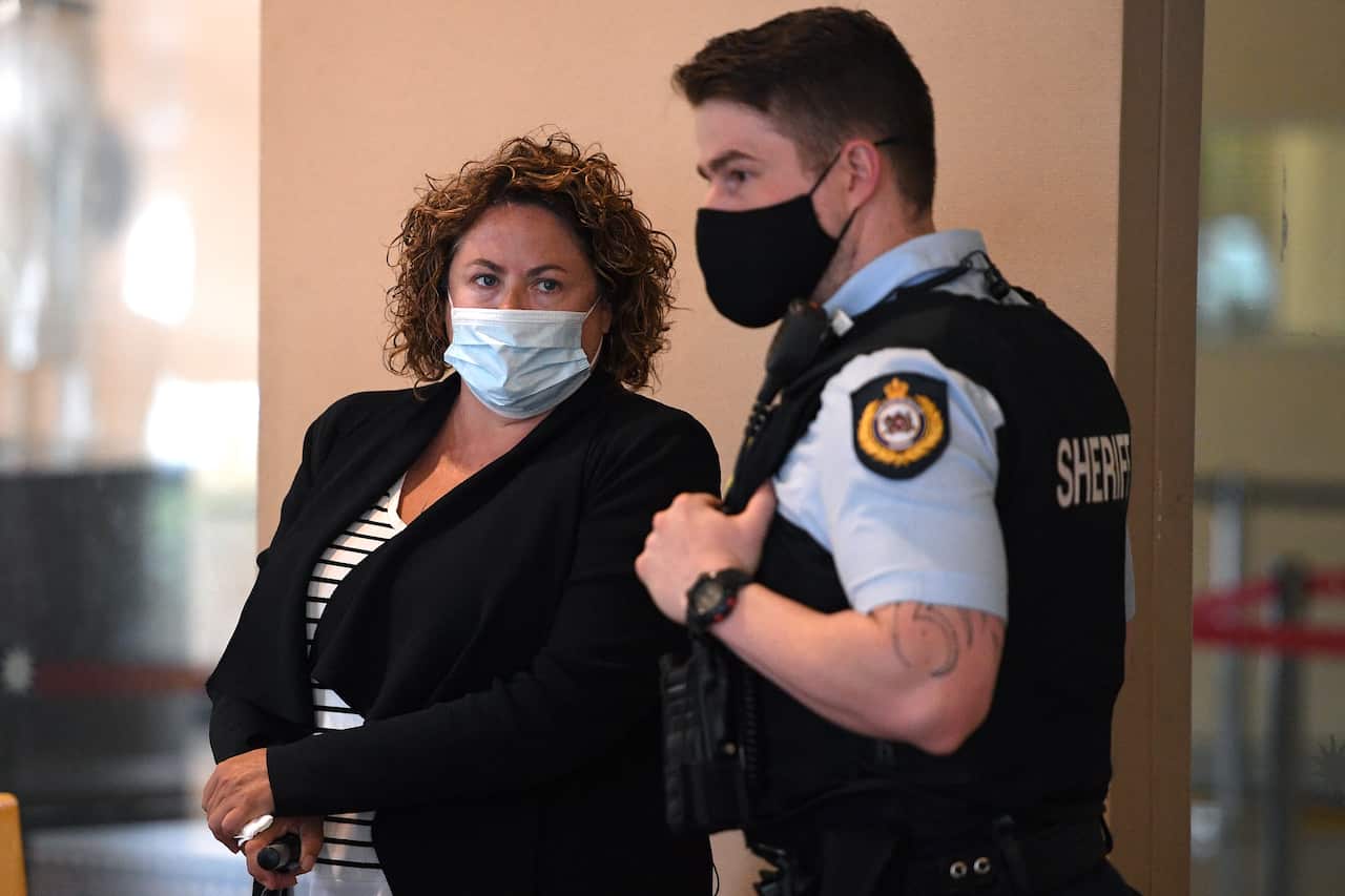 A woman standing next to a police officer