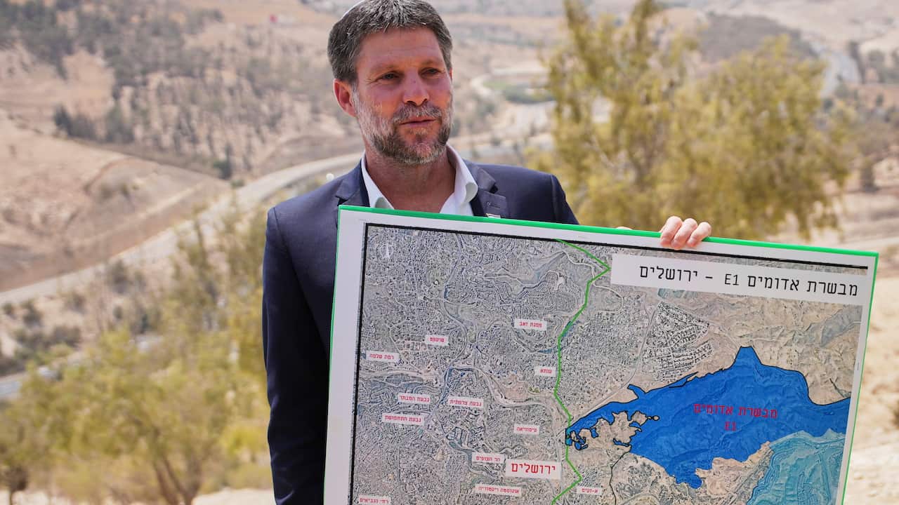 A man holding a large map.