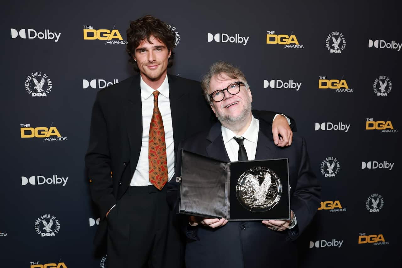 Jacob Elordi and Guillermo del Toro in black suits.