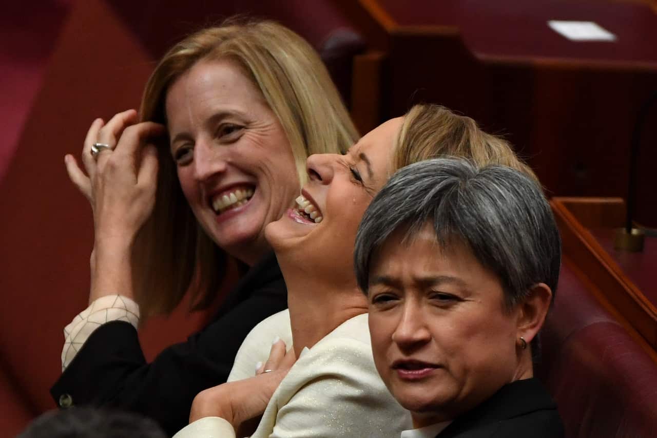 Labor senators Katy Gallagher, Kristina Keneally, and Penny Wong are seen laughing.