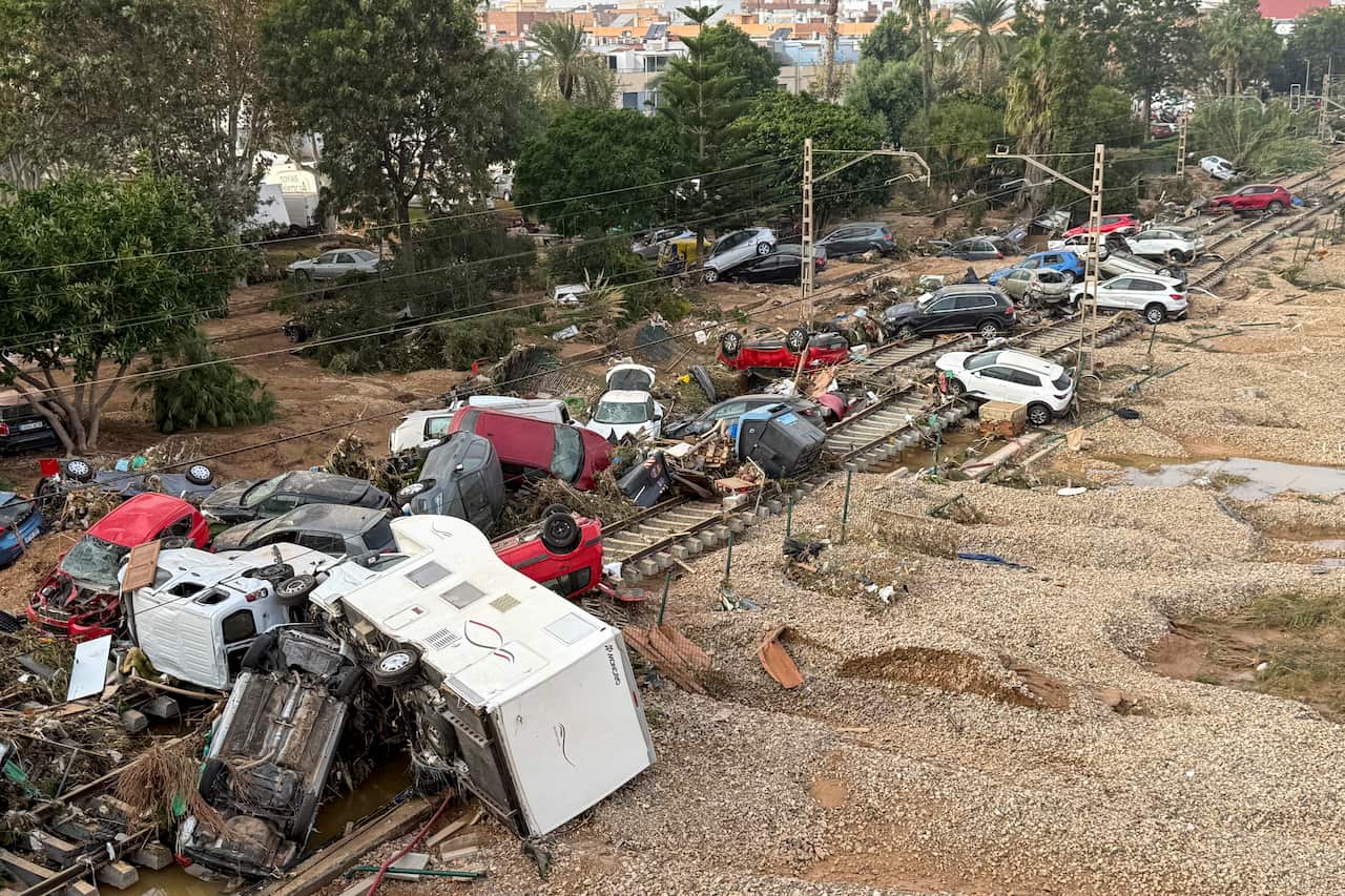 Cars and detritus cover a train track