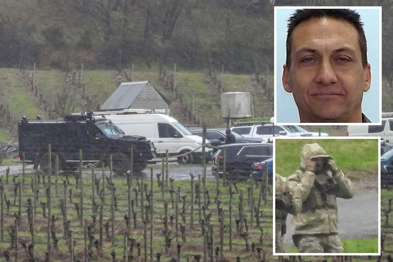 A main image with two other photos inset. Main picture is of a black armoured vehicle and a large white van among other cars in a car park. A vineyard is in the foreground. Inset top is a headshot of a man and below a man wearing light camouflage clothing.
