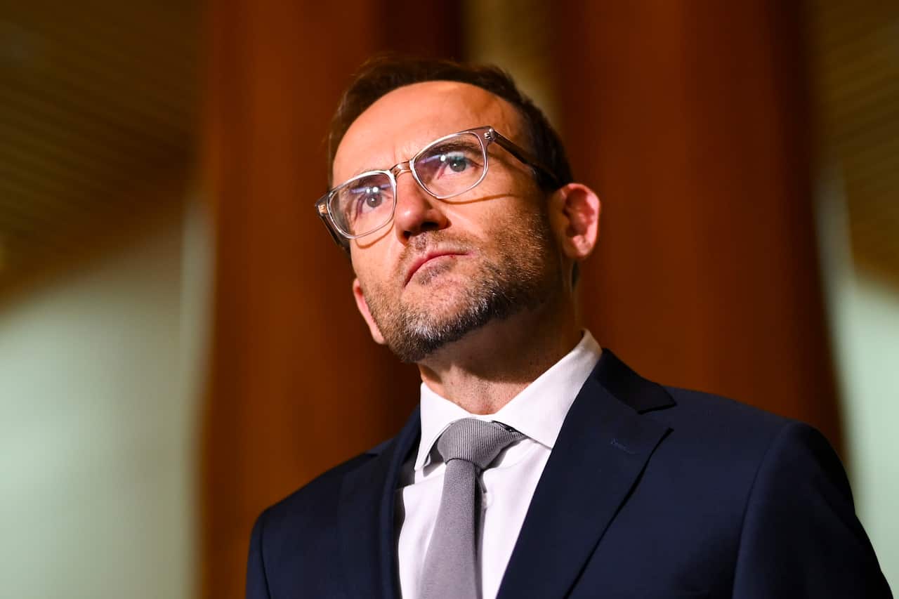 A man wearing a suit and glasses.