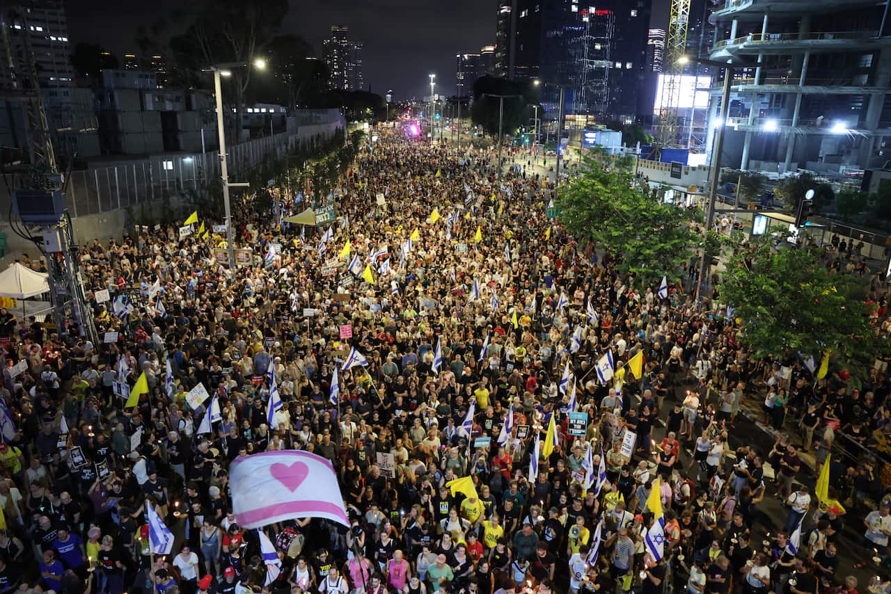 Families of Israeli hostages held by Hamas in Gaza and their supporters attend a protest calling on the government to sign a hostages release and ceasefire deal, outside the Kirya military headquarters in Tel Aviv,