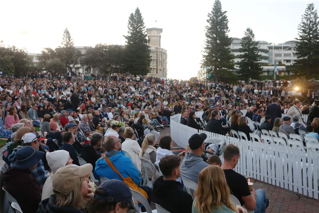 A large crowd of people seated outside 