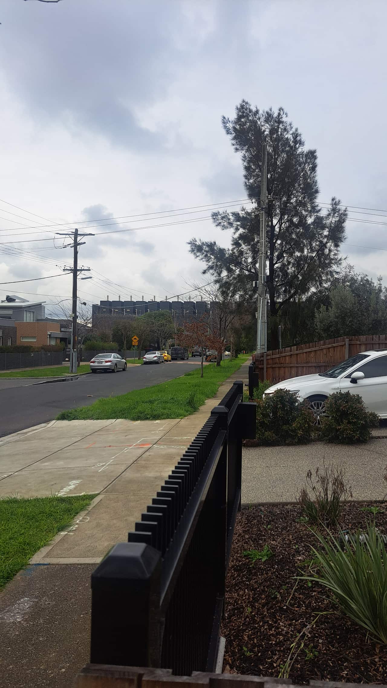 A view of a street with a large building in the background.