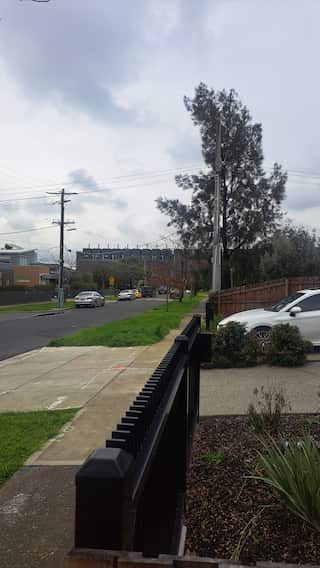 A view of a street with a large building in the background.