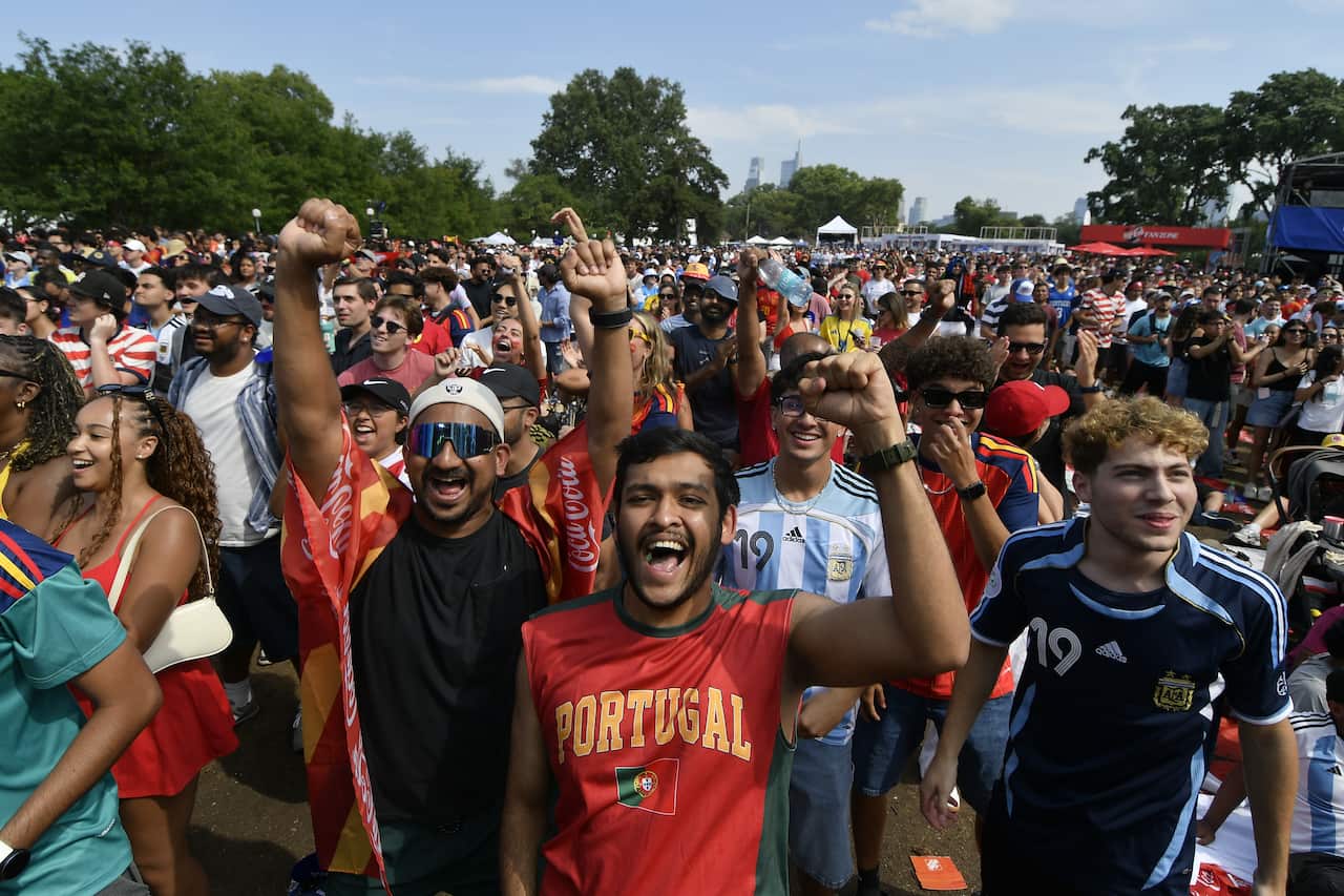 A large crowd of excited football fans at a public event.