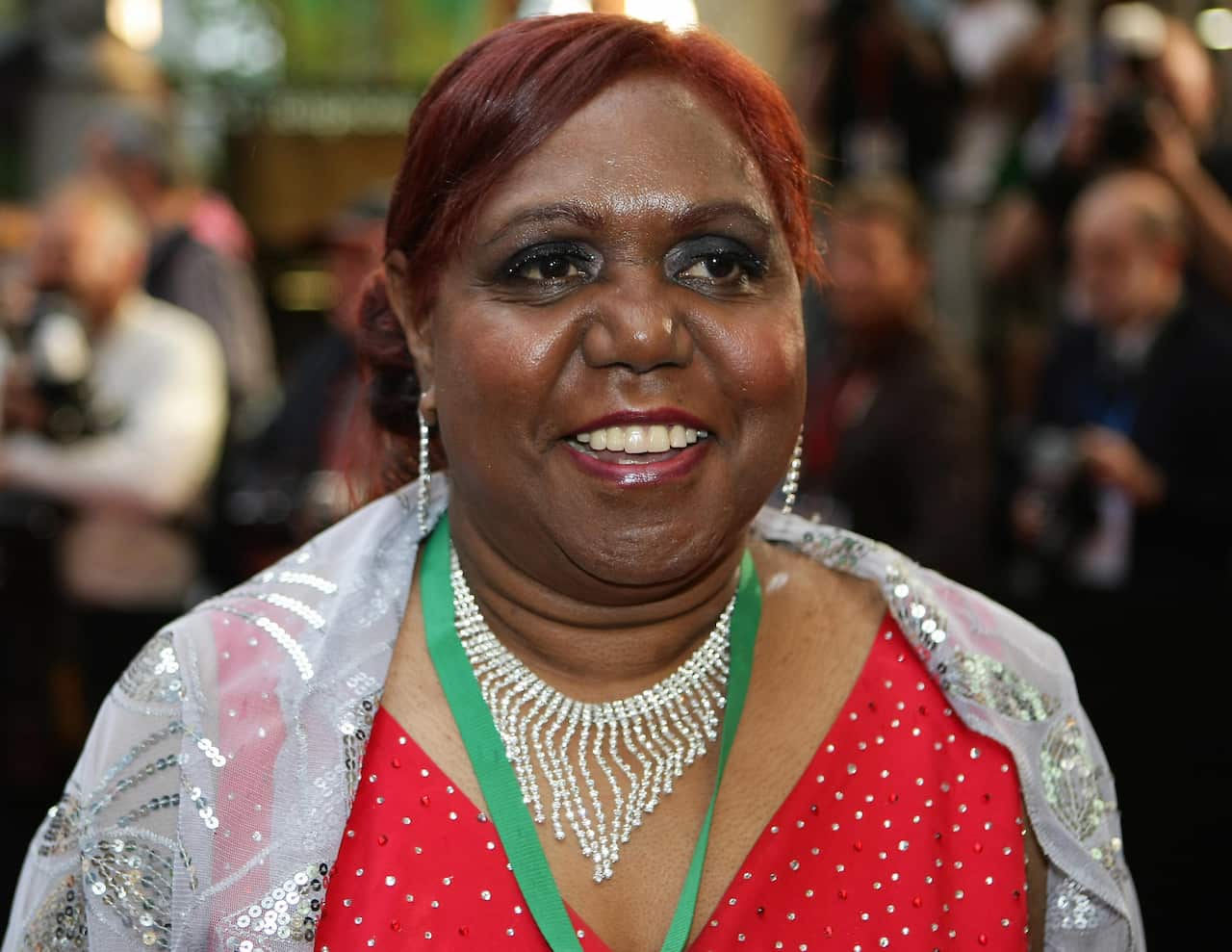 Aboriginal actress Lillian Crombie smilies on a red carpet