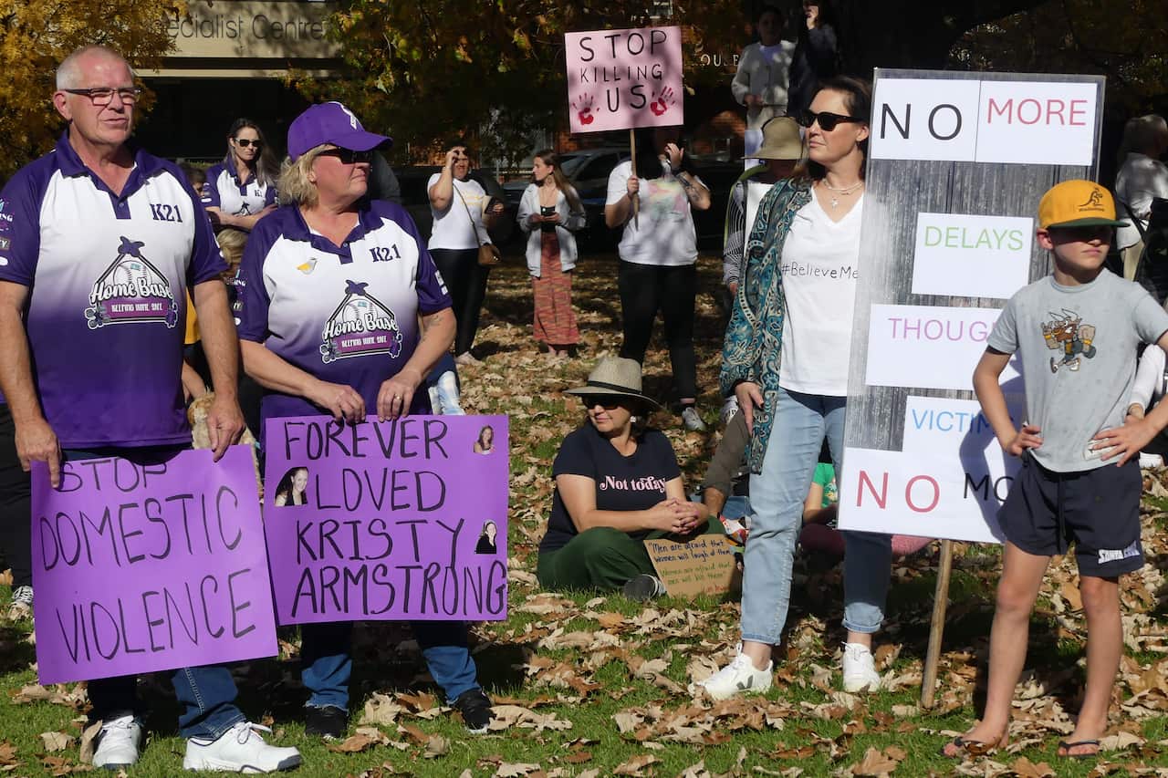 Men and women at a domestic violence rally