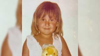 photo of a young blonde girl in a pink dress with a stuffed rabbit toy