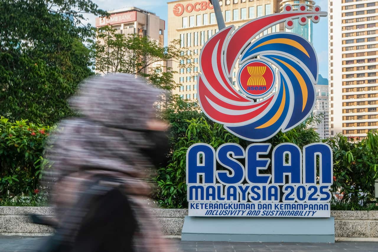 A woman seen passing by the logo of the 46th ASEAN Summit