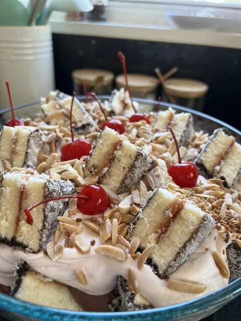 Cake slices and cherries on a blue plate.
