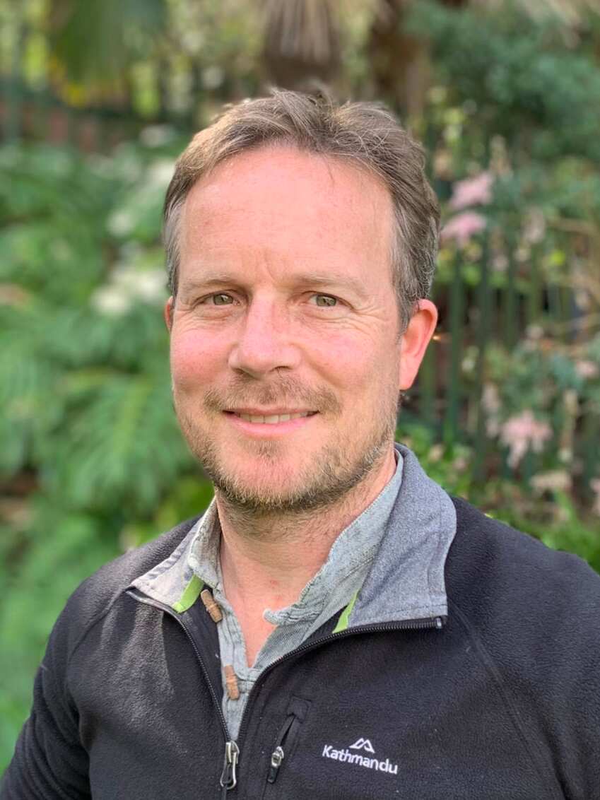 A man wearing a navy jumper.