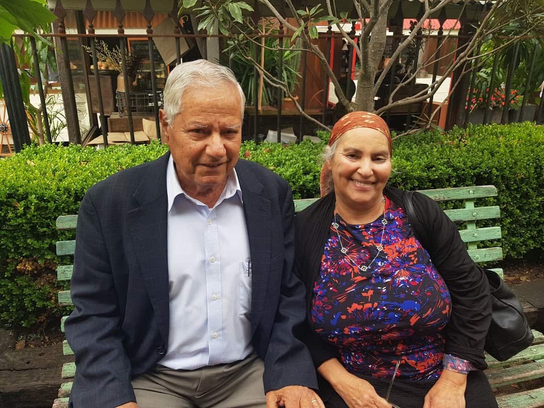 A man and woman sitting on a bench