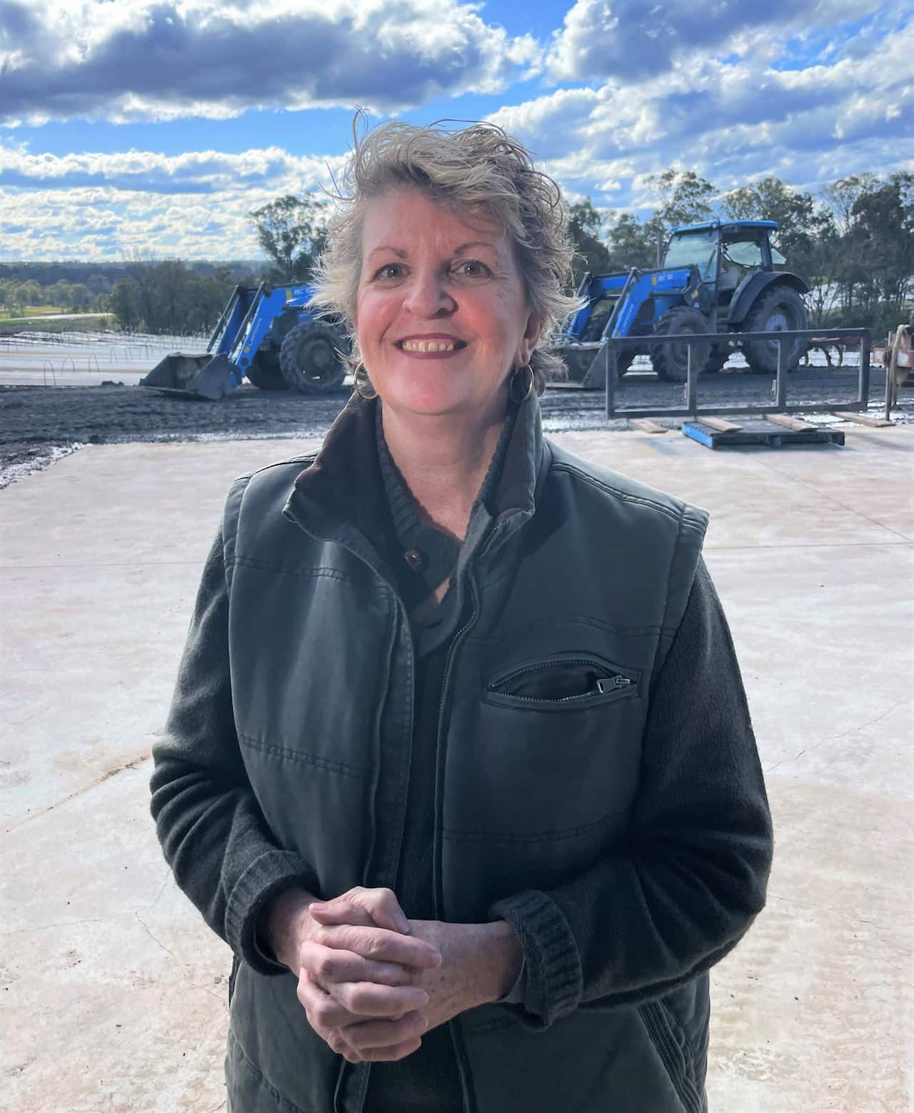 Box Divvy co-founder Jayne Travers-Drapes standing in front of tractors