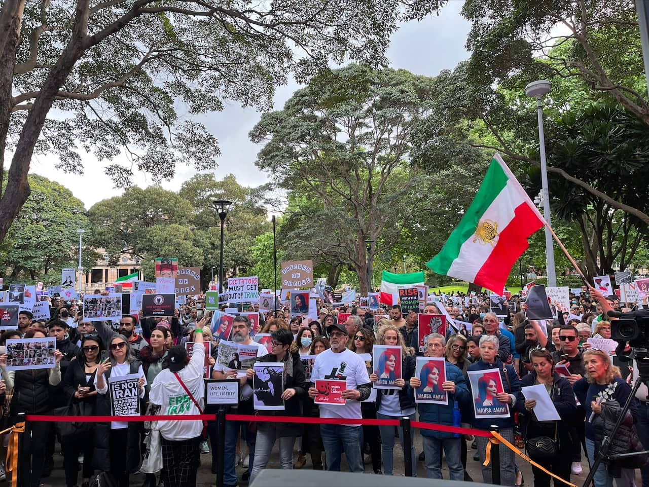 People are seen gathering in Sydney's Belmore Park to protest the Iranian government's regime. 