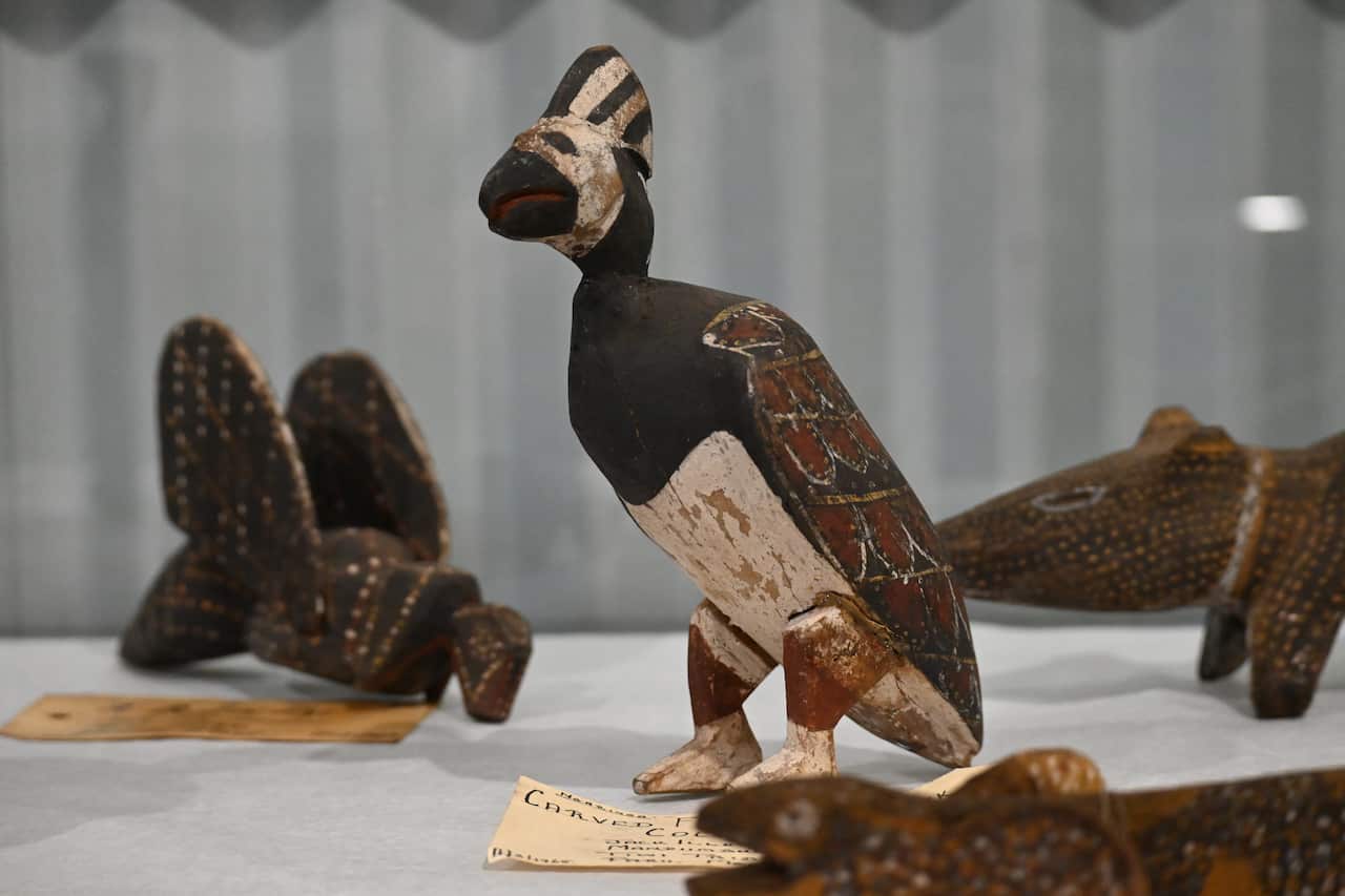 A carved cockatoo and other wooden objects