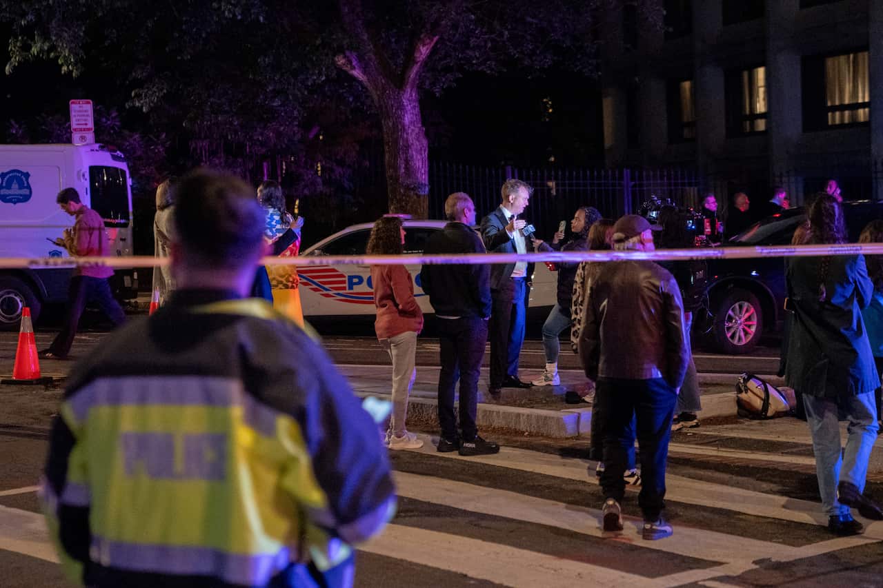Police officers at a cordoned off area.