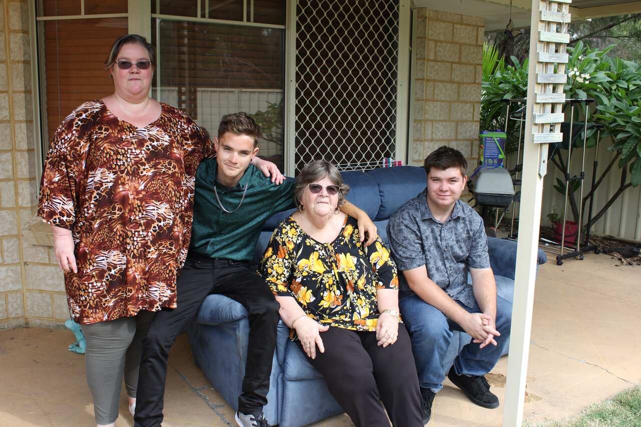 Four family members sit on a couch. 