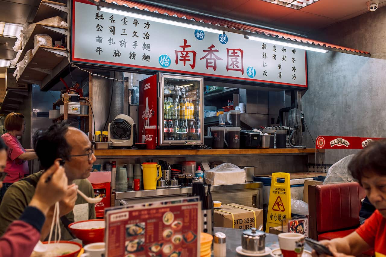 Image shows people in a Hong Kong cha chaan teng