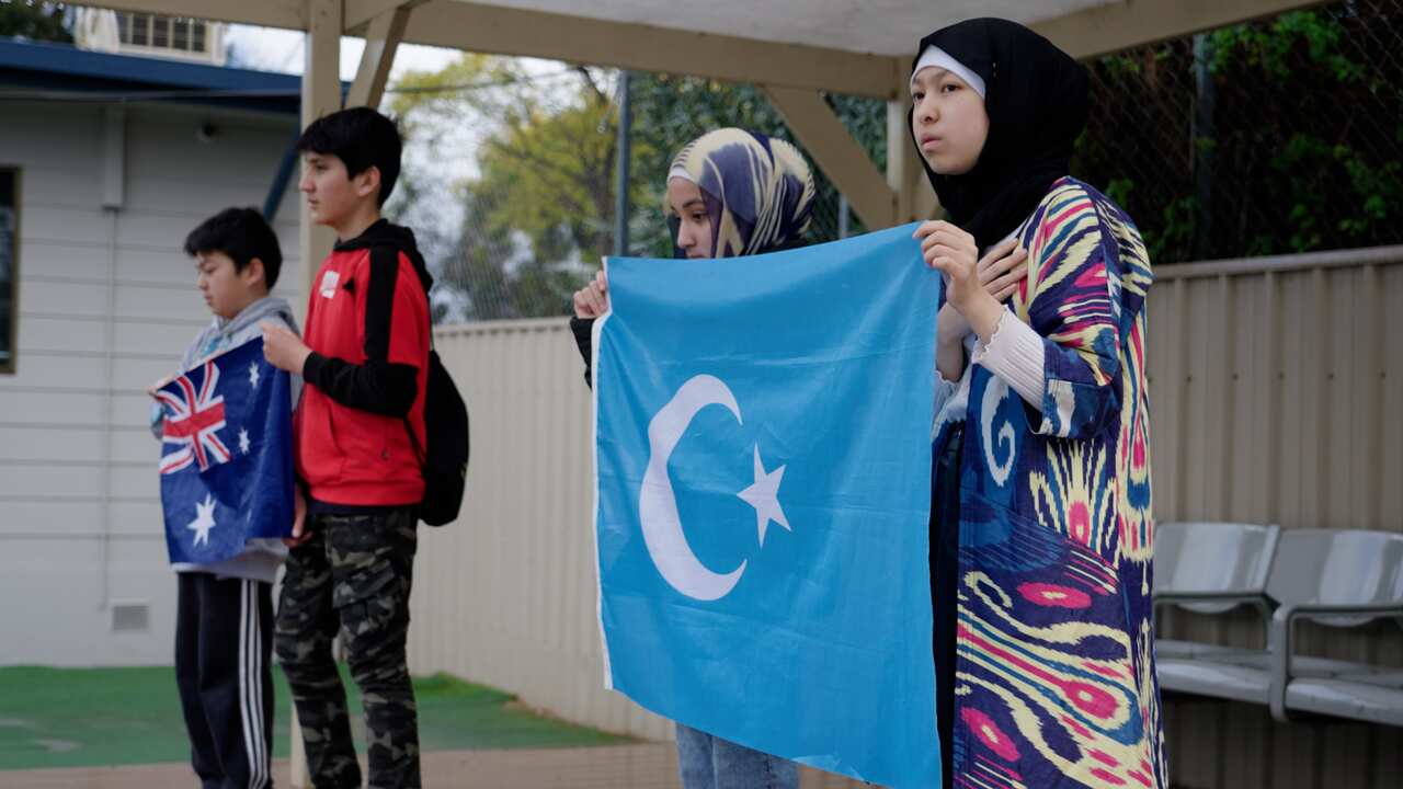 Four students holding flags.
