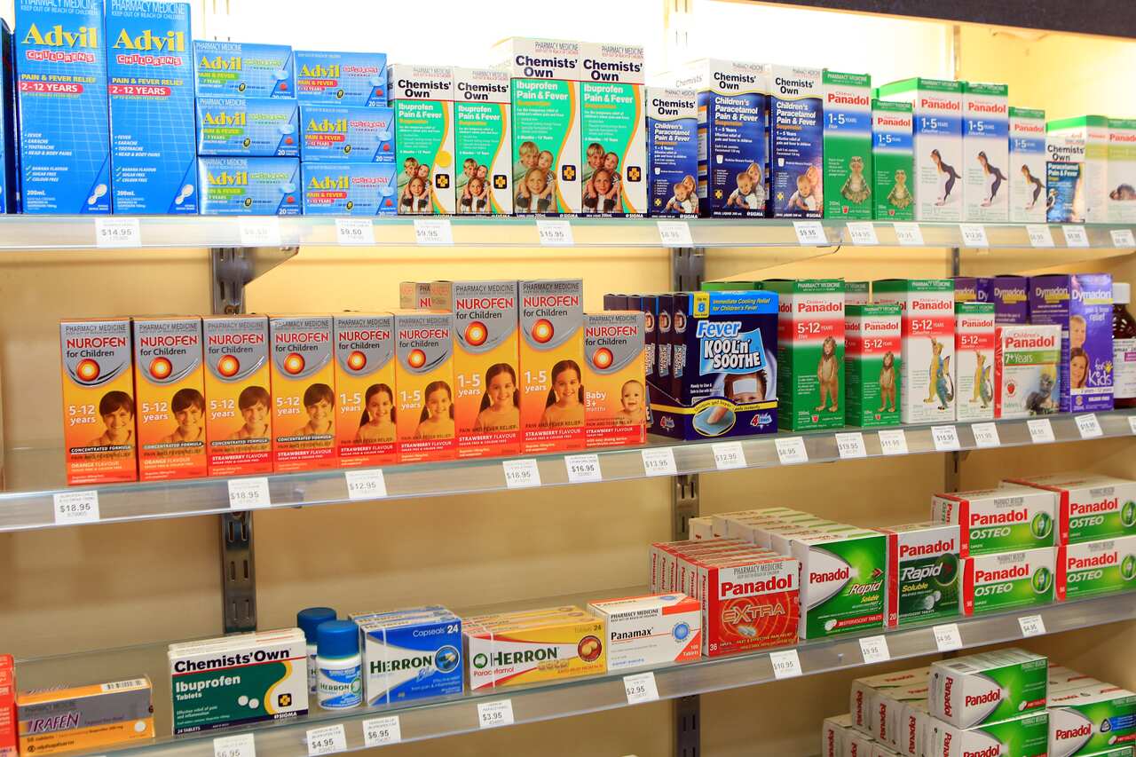 A shelf showing many boxes of different medications