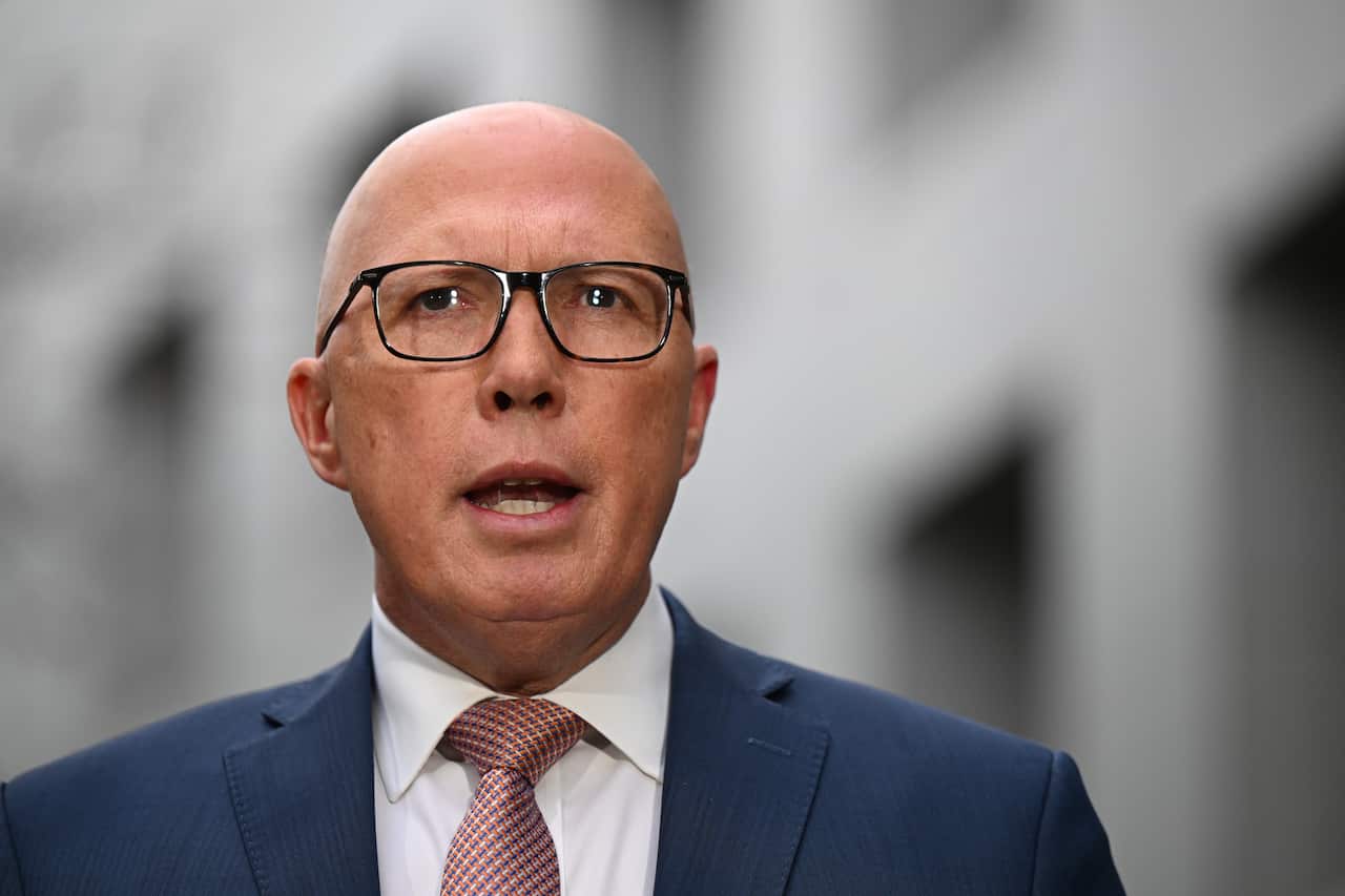 A man wearing glasses and a tie