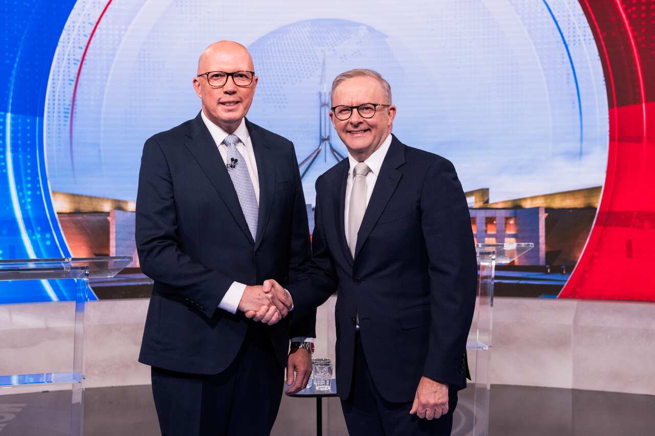 Peter Dutton and Anthony Albanese shake hands. 