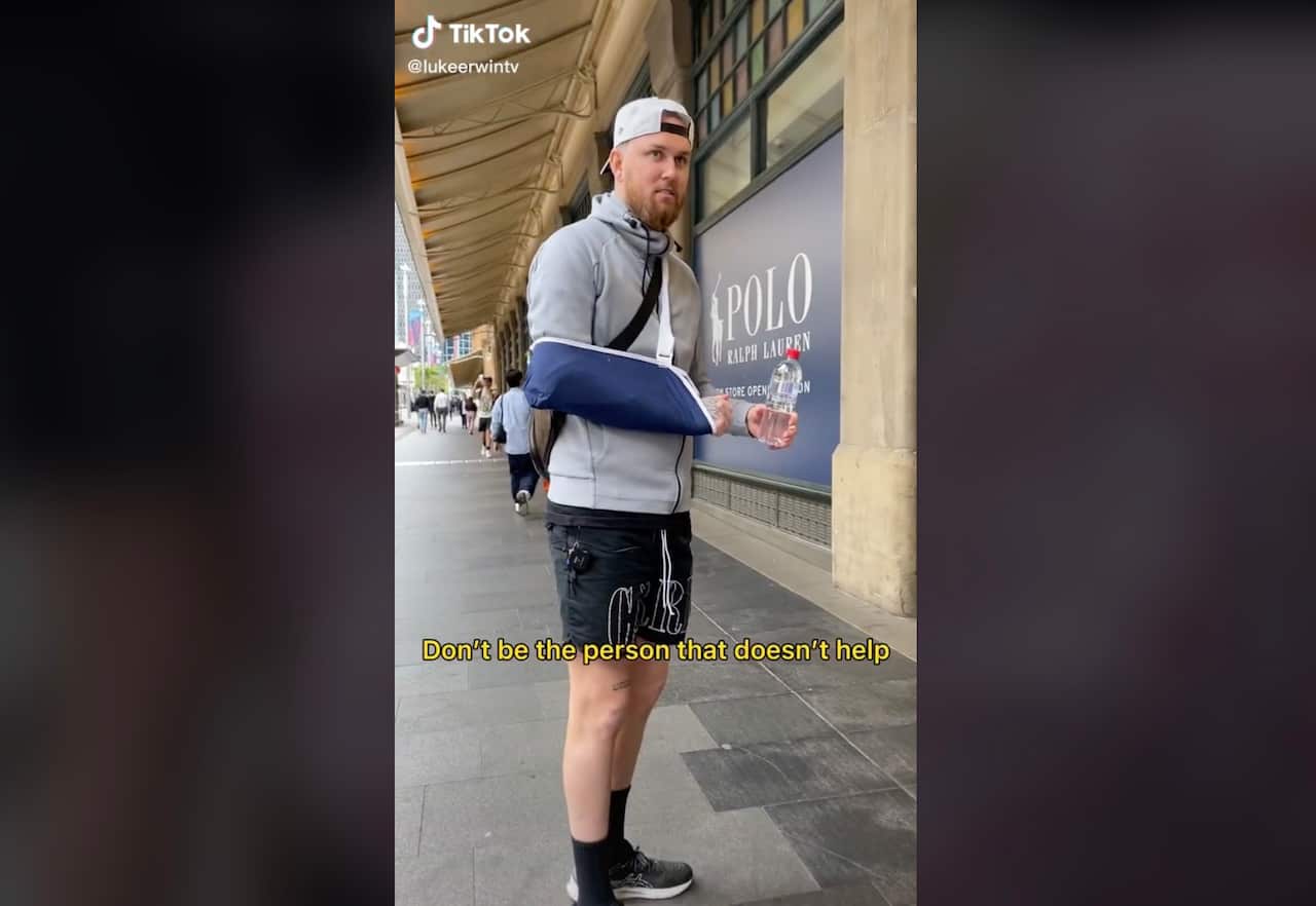 A man with his arm in a sling and the caption 'Don't be the person that doesn't help'