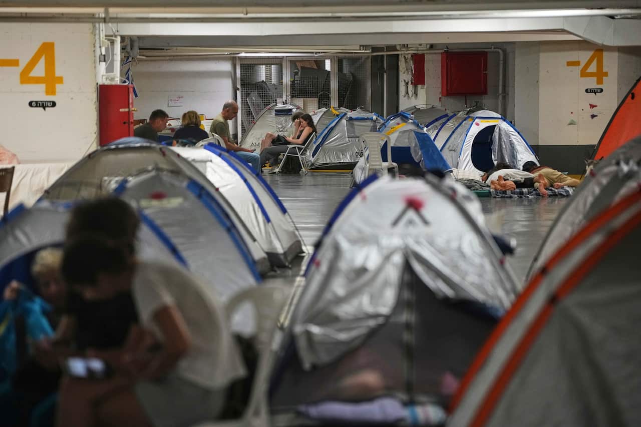 People and tents in an underground bunker.