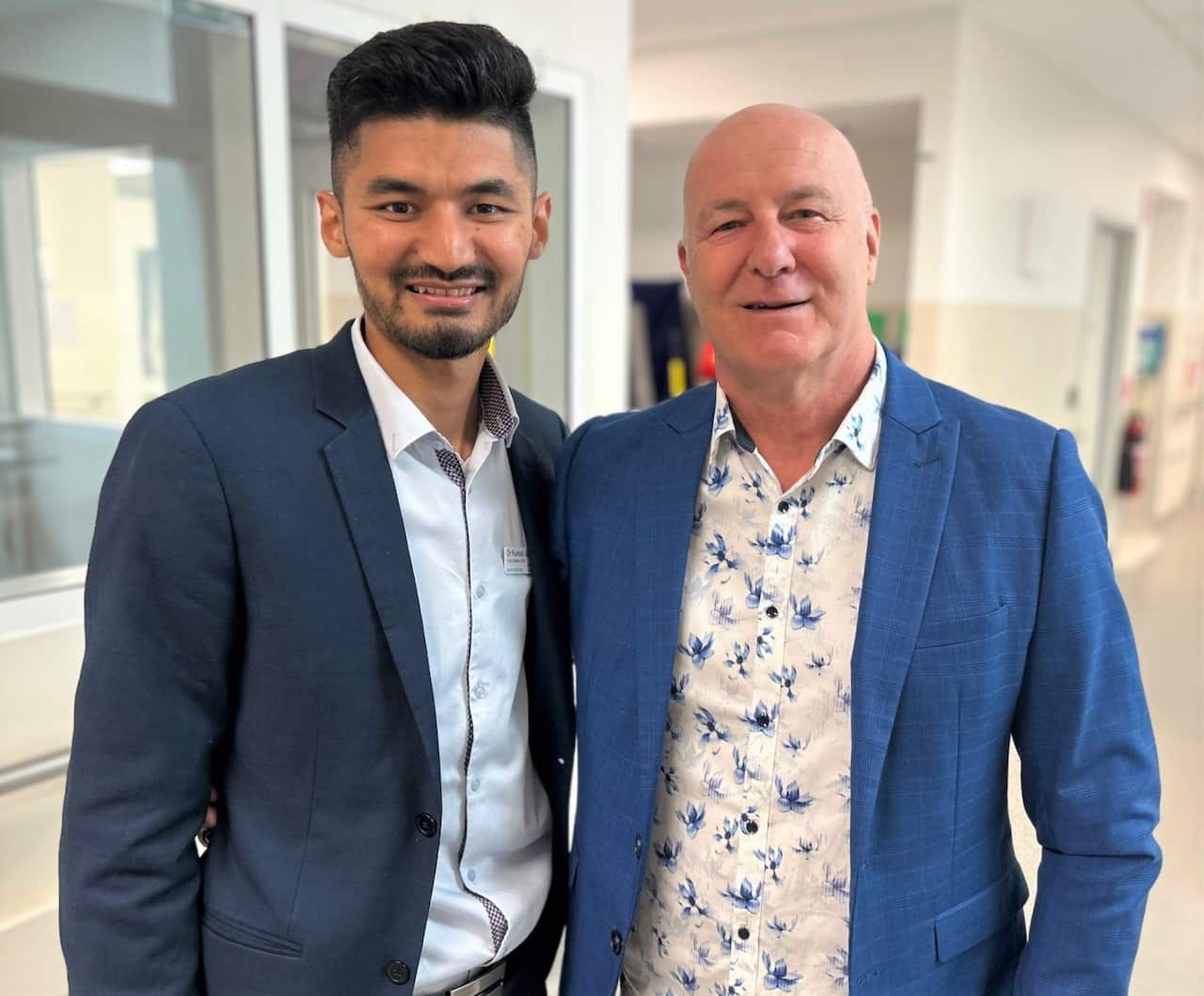 Kumail Jaffry (left) standing in a hospital corridor with another man