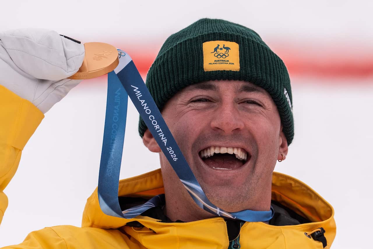 Cooper Woods holding gold medal. 