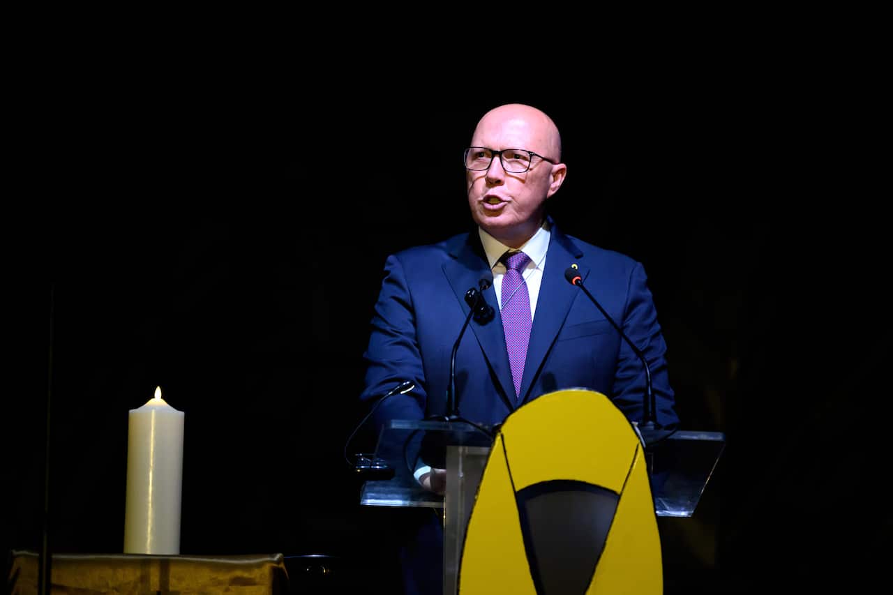 A man speaks at a podium.