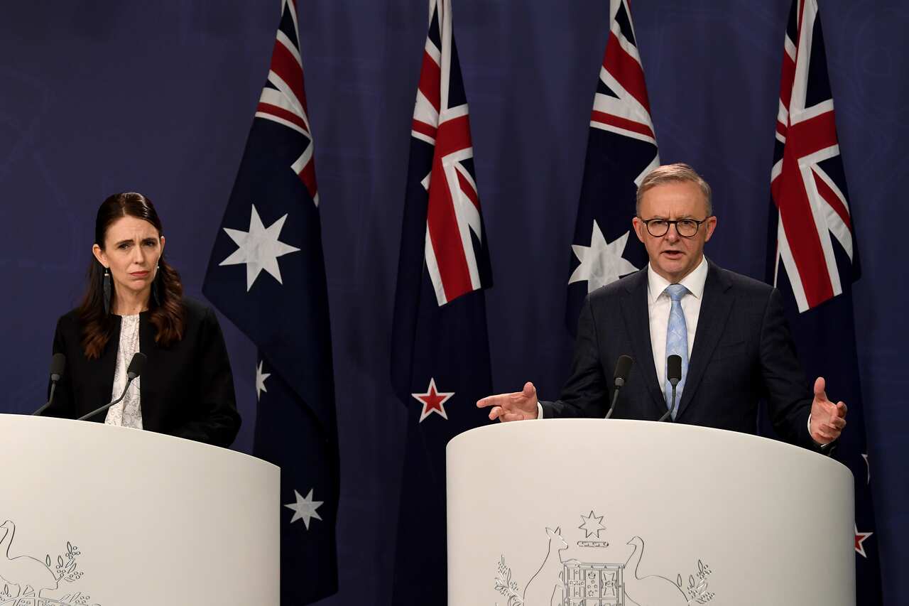 Jacinda Ardern (left) and Anthony Albanese stand behind lecterns
