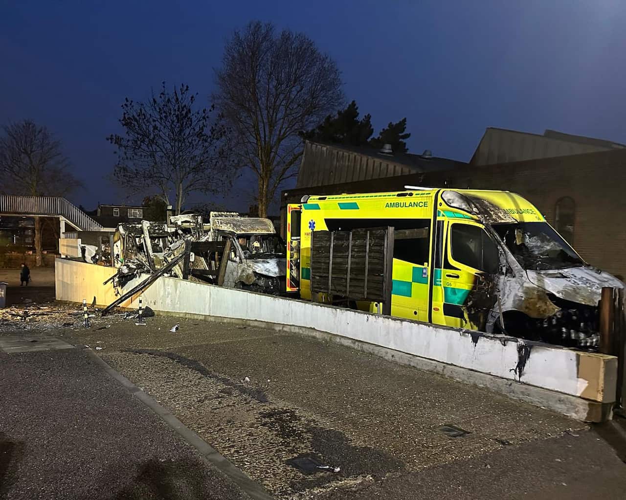 Several badly damaged ambulances parked in a row.