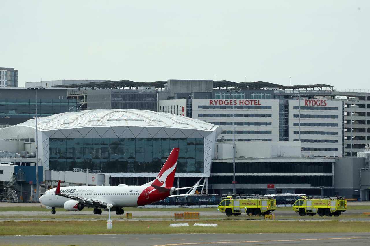 Two fire rescue vehicles approaching an aircraft on the tarmac.