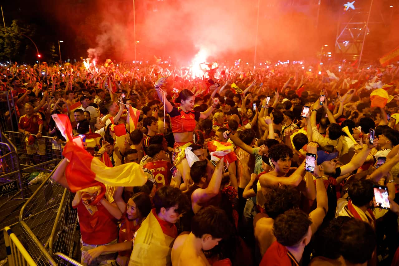 Spanish football fans celebrating in the streets of Madrid