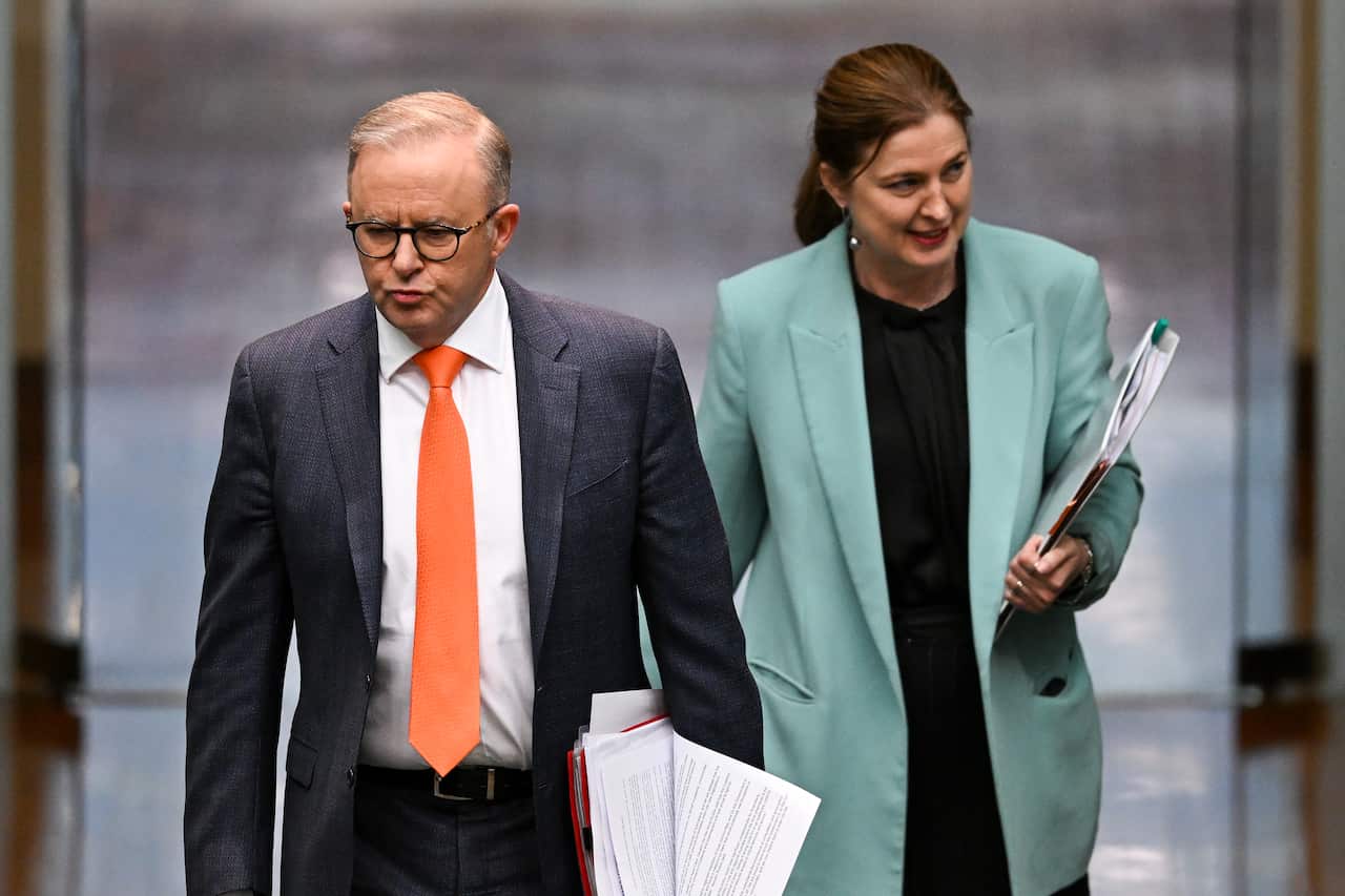 Anthony Albanese and Julie Collins walk together.