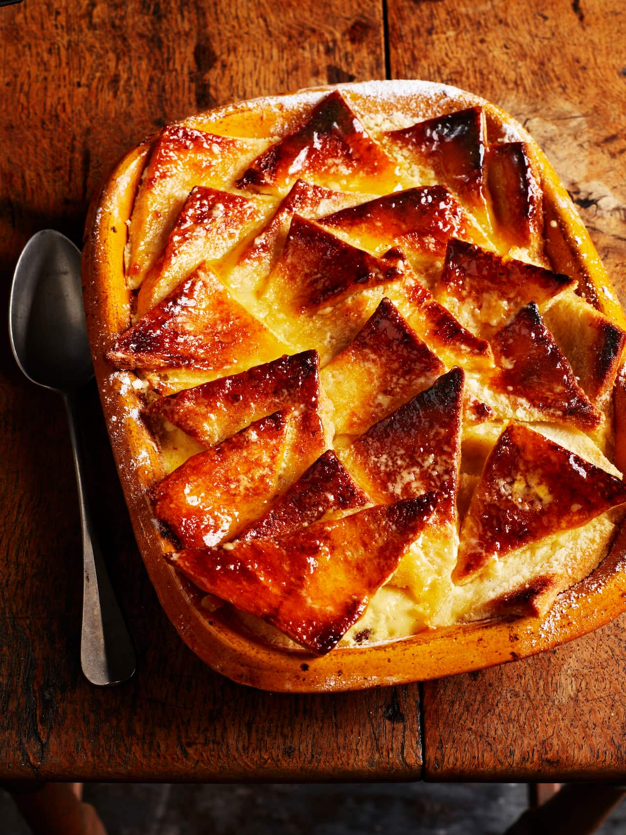 Caramelised bread and butter pudding with sultanas and apricot glaze