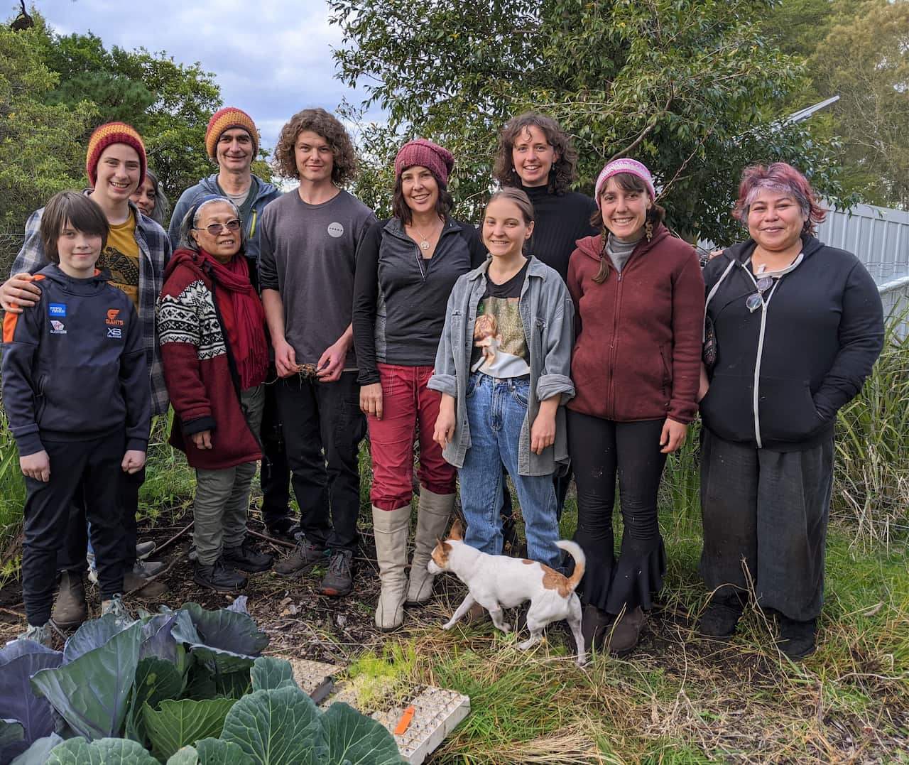 A group of volunteers standing in a garden.