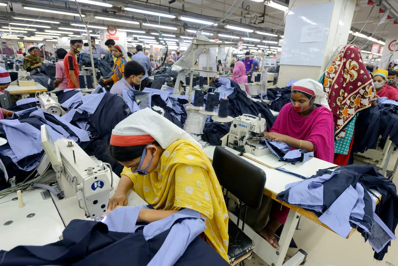 Workers sew clothes at a garment factory in Dhaka, Bangladesh.