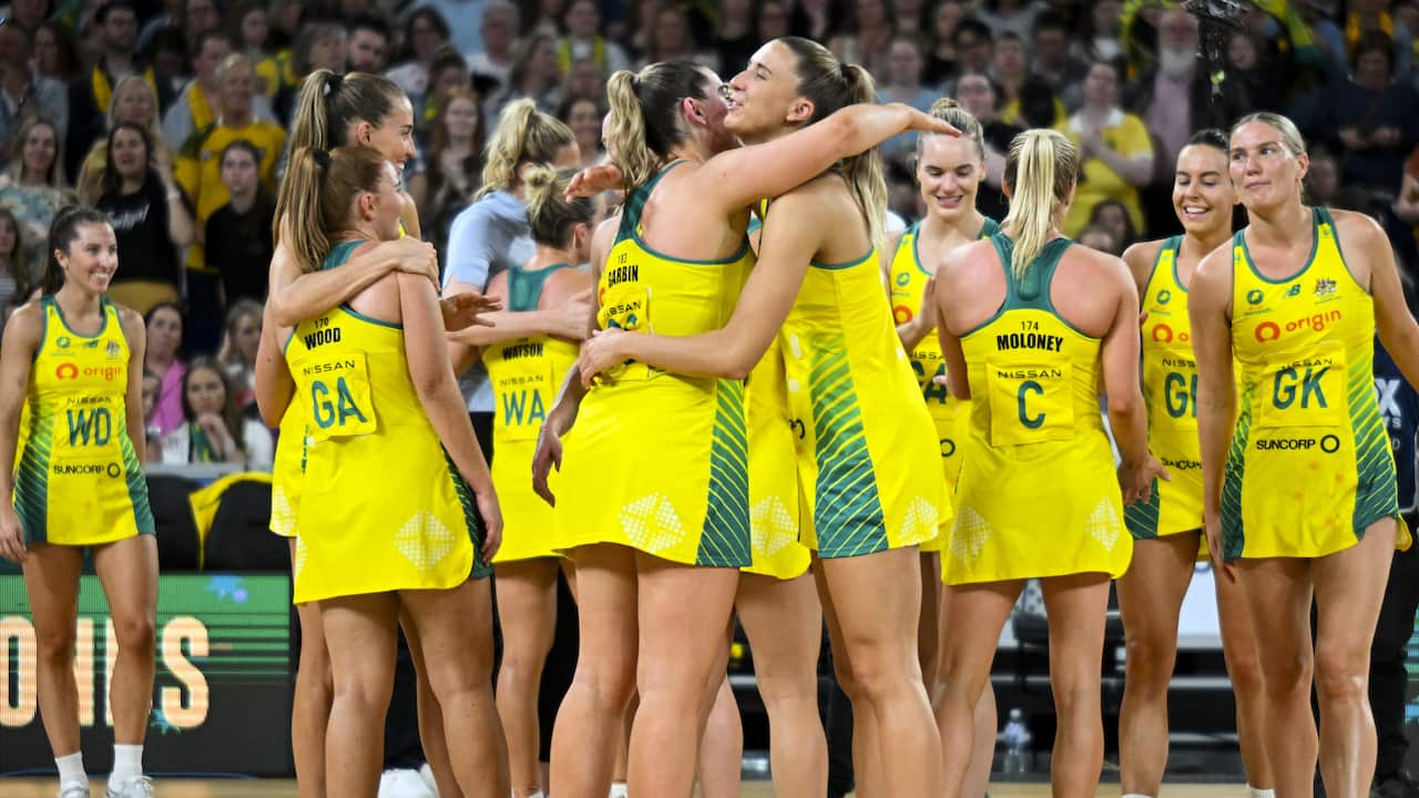 Australian Netball players celebrate on court.