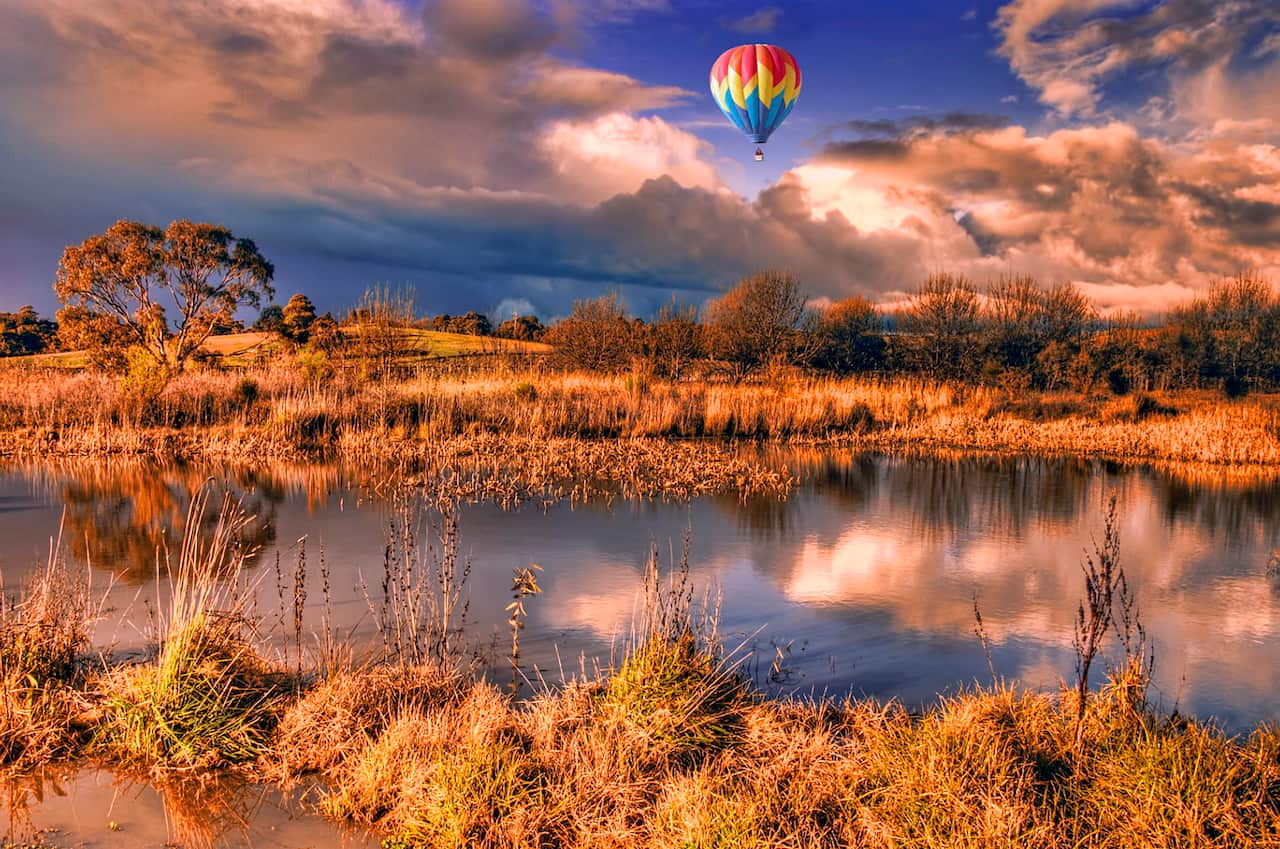 Hot air balloon over lake