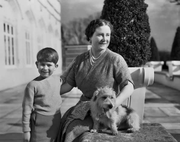 Prince Charles as a boy in 1954 with Queen Mother and pet dog.