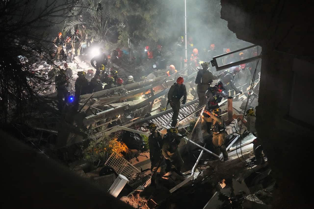 Rescue crews standing in collapsed building in the dark