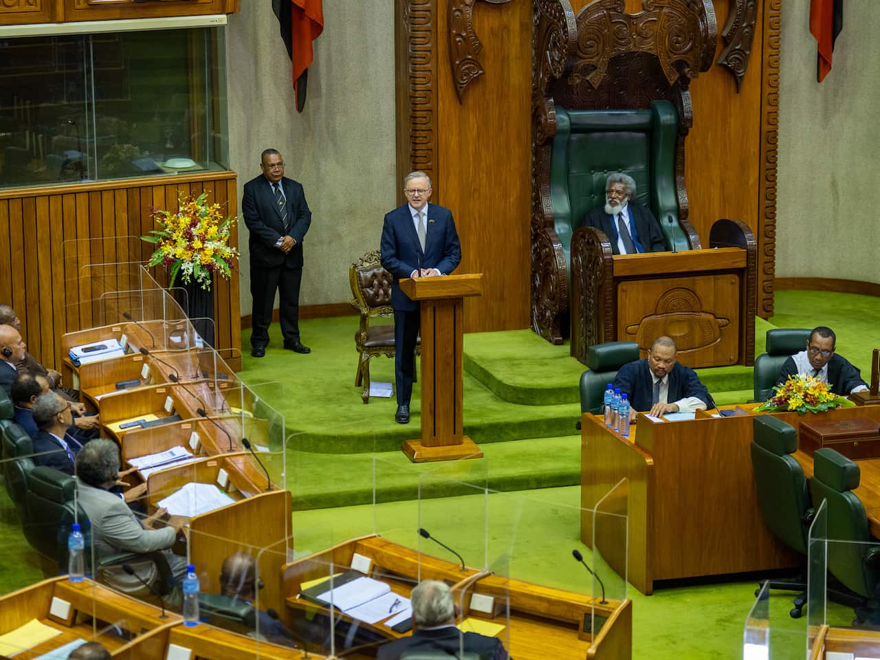 Anthony Albanese standing behind a lectern in the Papua New Guinea parliament